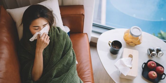 person lying on sofa feeling unwell