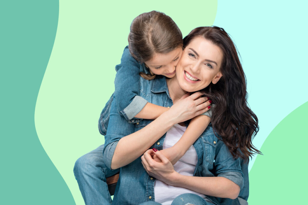 happy mother with daughter climbing on her back