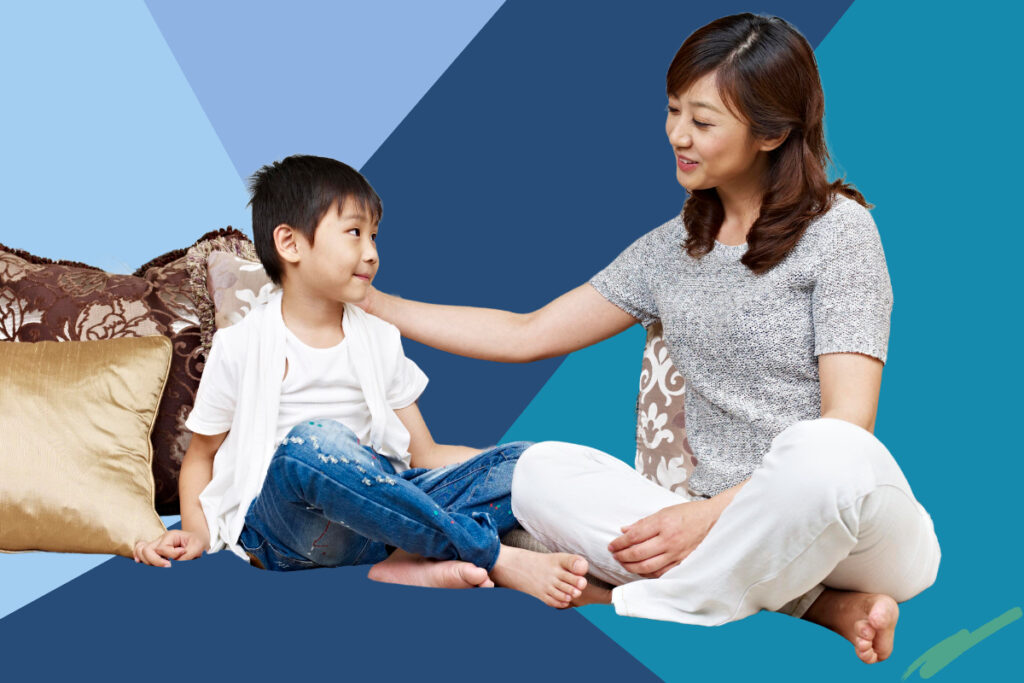 mother puts hand on boys shoulder sitting on the floor mom-and-son time
