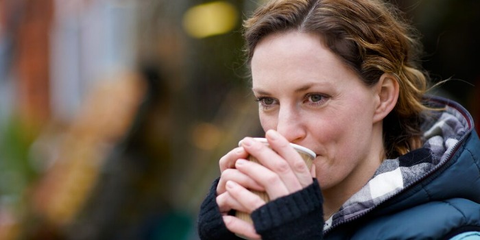 person sipping on a drink ourdoors