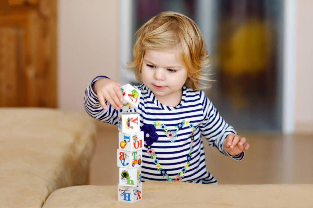child stacks up blocks montessori for parents