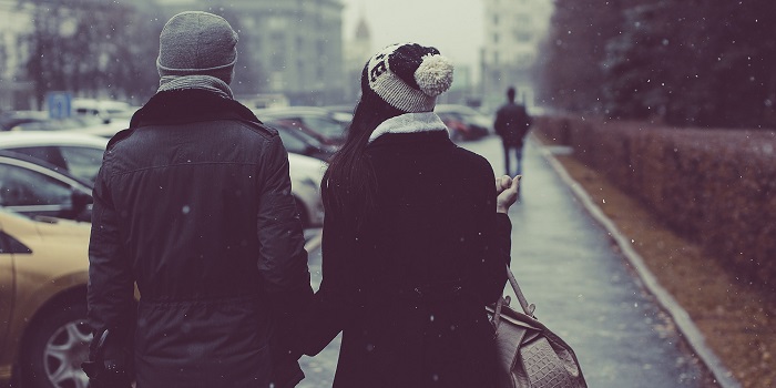 male and female couple walking outdoors in winter