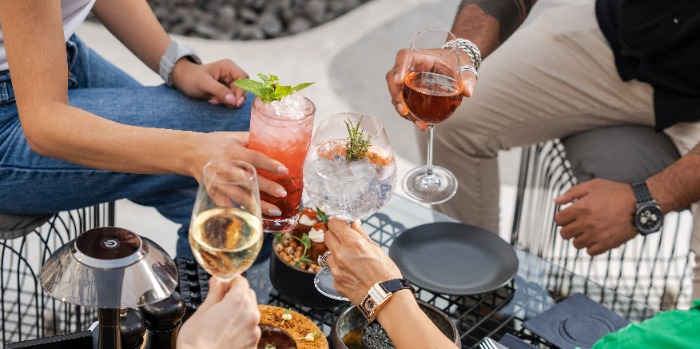 group of people cheering with drinks in hand