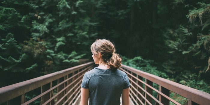 A woman standing on a bridge