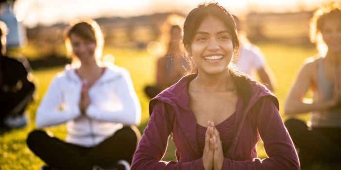 a group of people in a yoga class outdoors