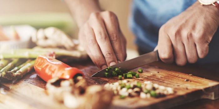 person cutting veg