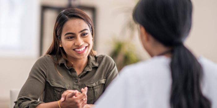 Comment réduire le risque de cancer du col de l’utérus two people chatting and smiling