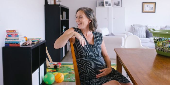 happy pregnant person at home