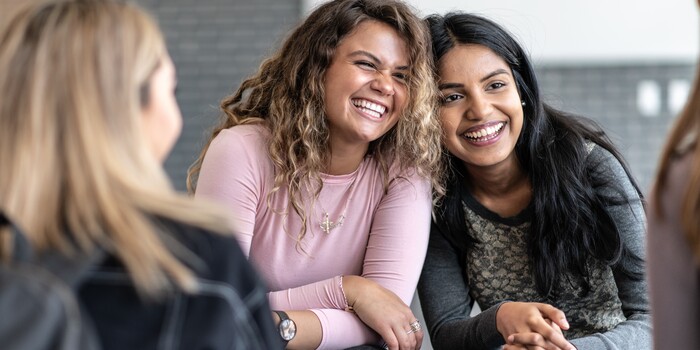 two people laughing in a group