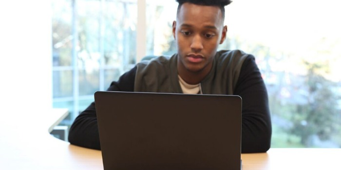 Teenager browsing on a laptop