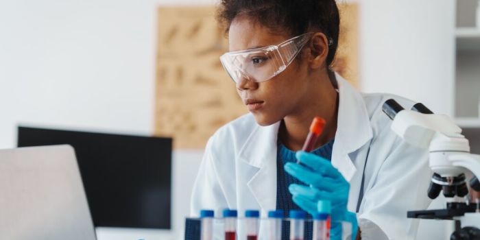A person studying a test tube