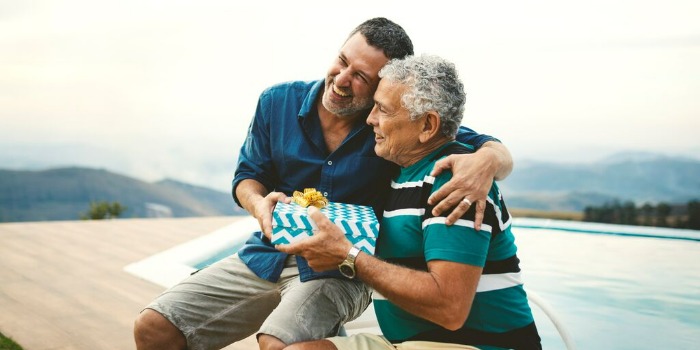 older man giving a gift to a younger man