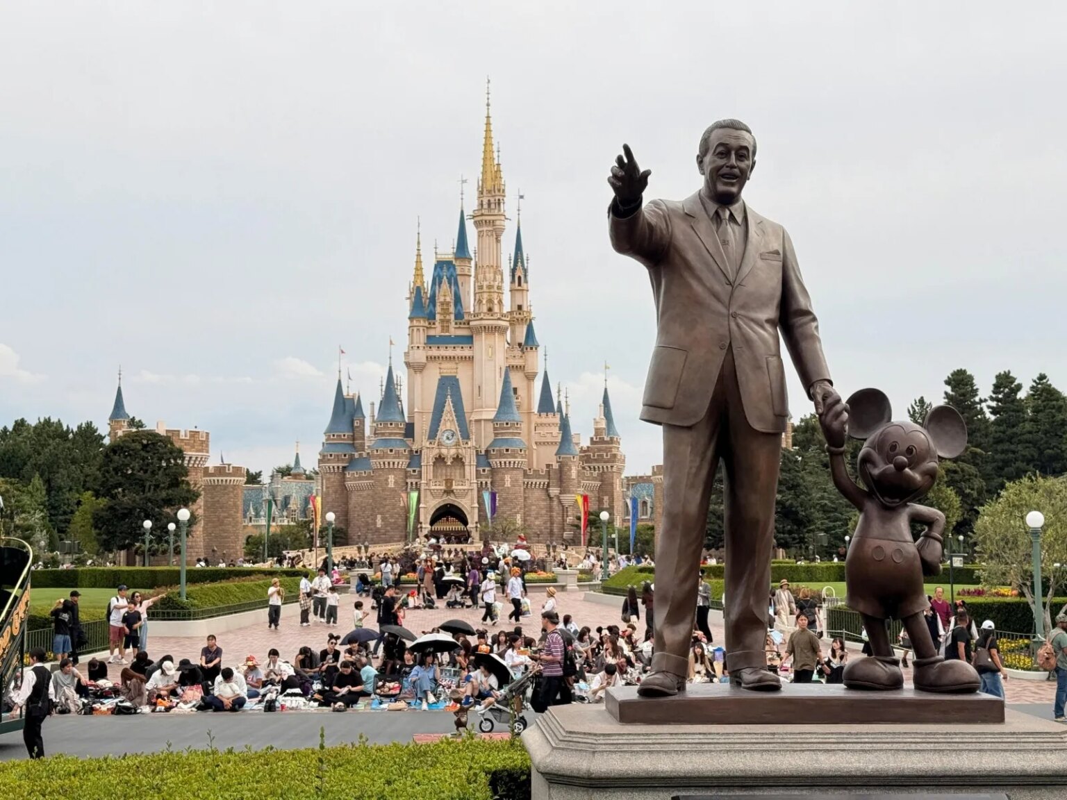 Statue of Walt Disney and Mickey Mouse in front of Cinderella Castle, Tokyo Disneyland.
