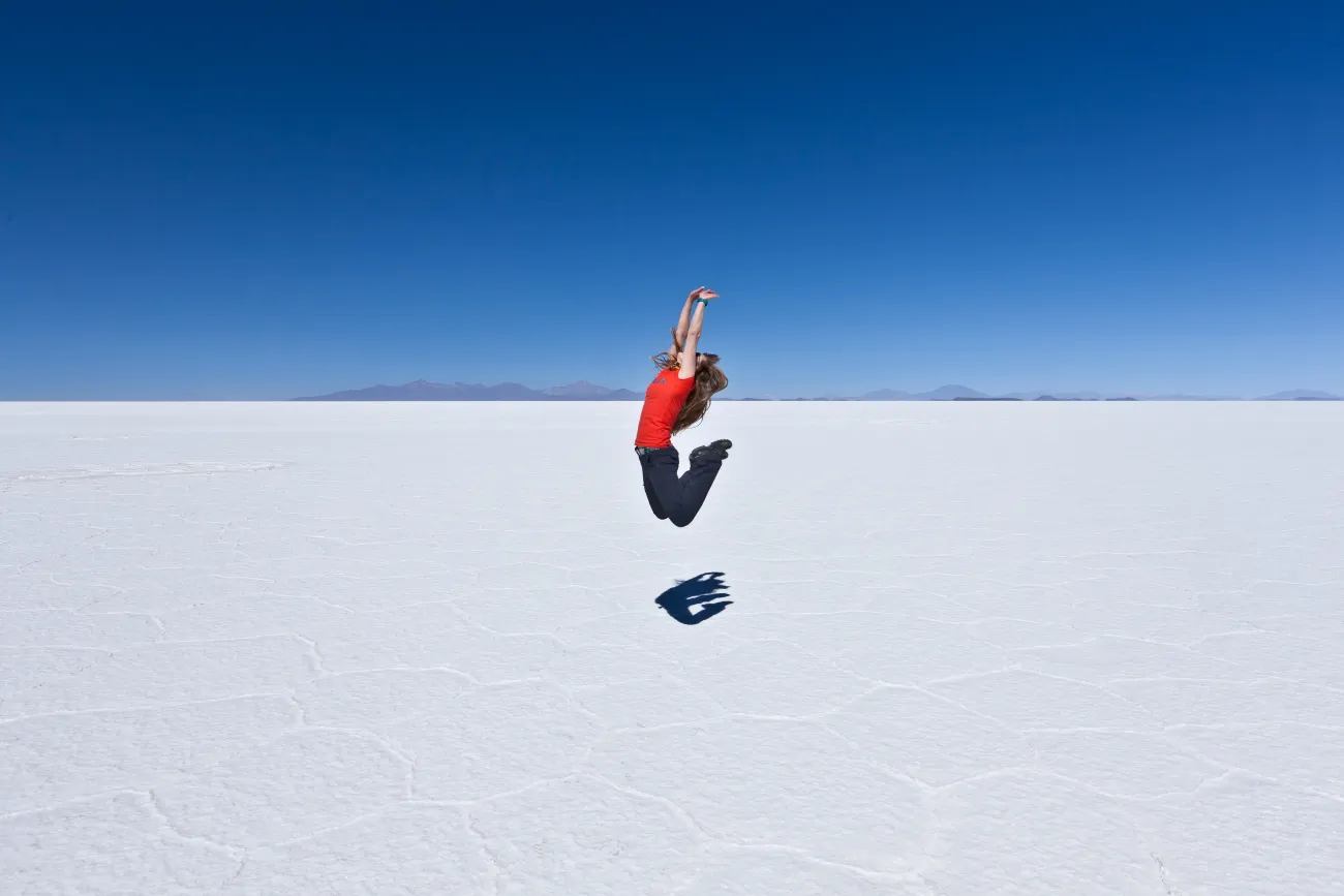 Femme sautant dans le ciel sur le salar d'Uyuni en Bolivie